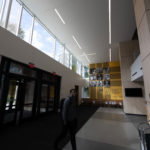 A student in the atrium of the newly-renovated Lowry Center at ϲʿֱֳ.